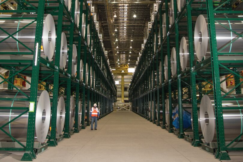 A worker standing next to Dexco 线圈 Rack Storage Systems