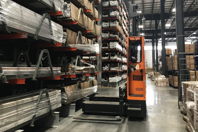 Forklift placed next to Dexco Racking System